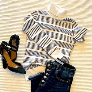 Striped white and black turtle neck sweater.